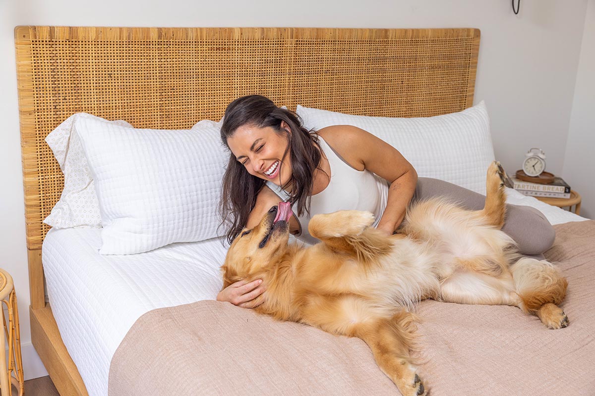 woman and dog on bed