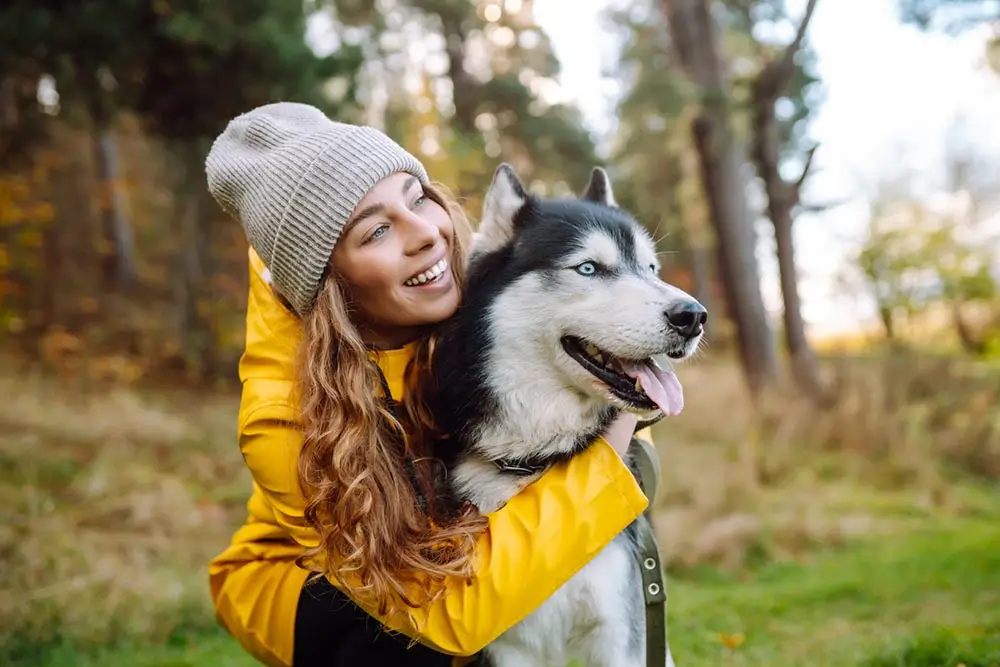 woman hugging her husky