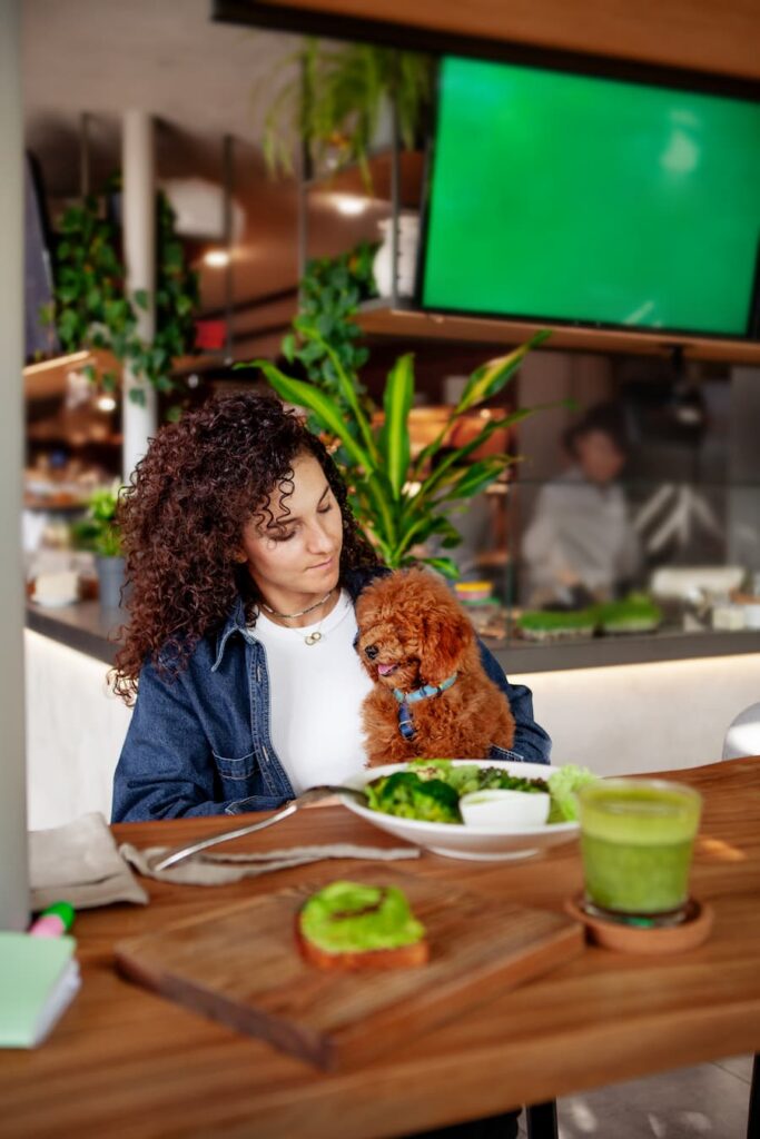 woman eating guac with her dog