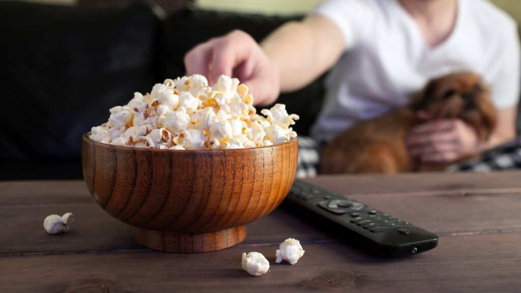 Eating popcorn with dog
