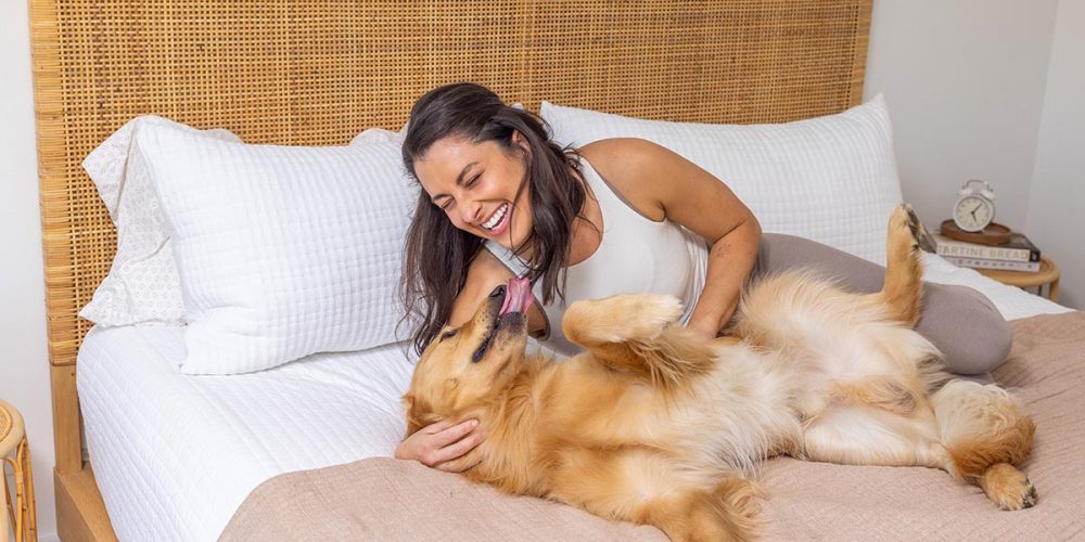 woman and dog on bed