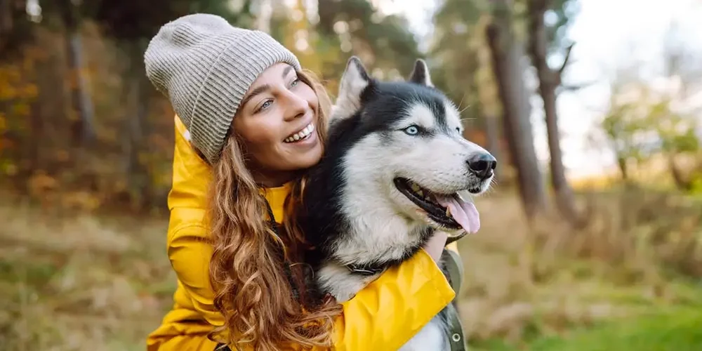 woman hugging her husky